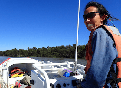 Alexandra piloting a boat in the delta