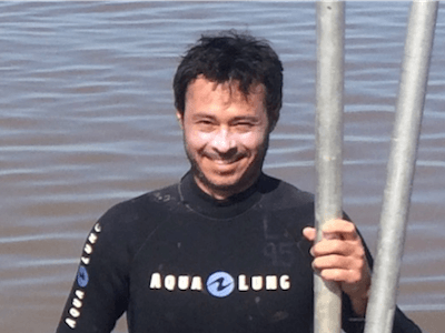 Headshot of Andre Rovai with water in the background