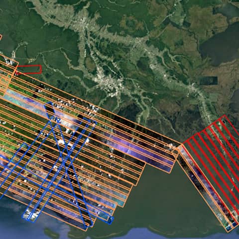 Dozens of rows of parallel flight line AVIRIS swath images overlaid over Google Earth