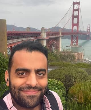 Hussain smiles in the bottom left corner with the Golden Gate bridge in the background