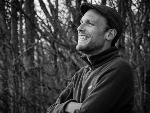 Black and white headshot of Olivier Gourgue with woods in the background